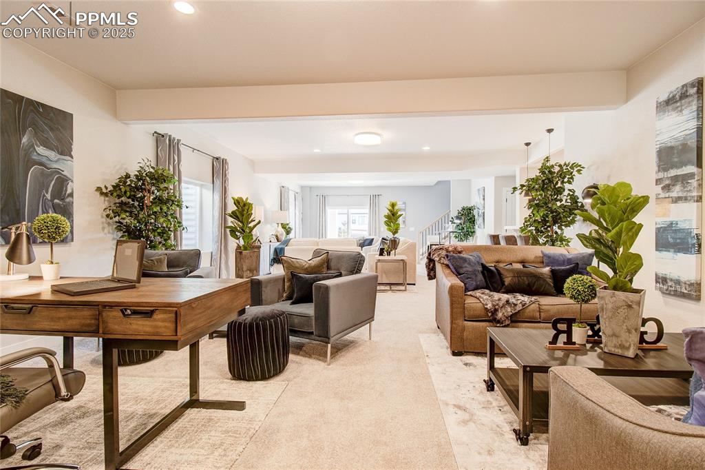 Image 17 of 19: Living area with plenty of natural light, recessed lighting, light carpet, 