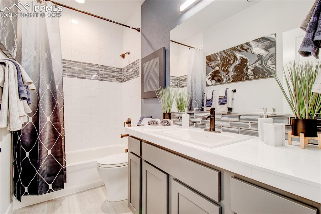Image 19 of 19: Full bath featuring vanity and shower / tub combo with curtain