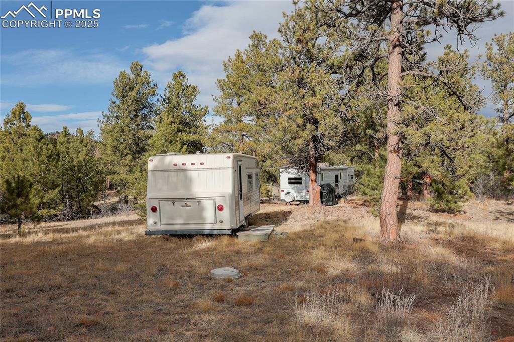 Image 10 of 22: View of yard with view of wooded area
