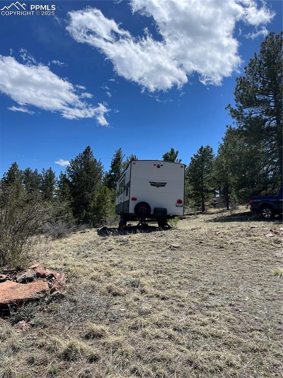 Image 18 of 22: View of yard featuring view of scattered trees