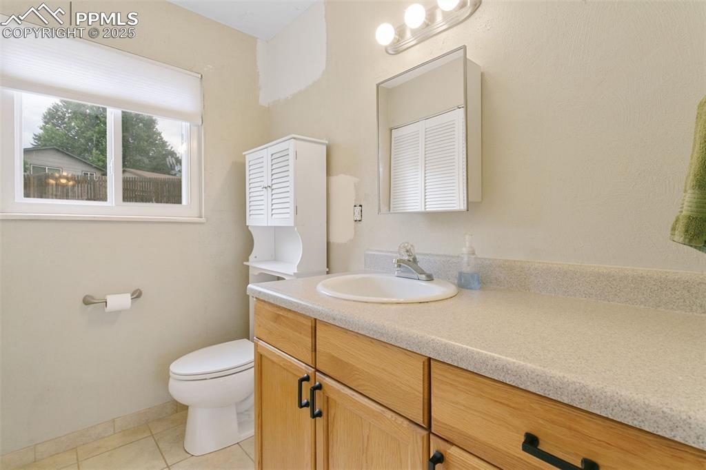 Image 16 of 26: Bathroom with vanity and tile patterned flooring
