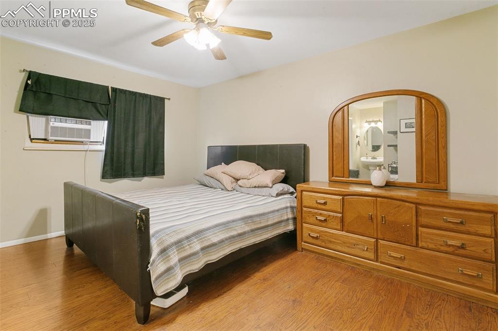 Image 18 of 26: Bedroom featuring wood finished floors and a ceiling fan