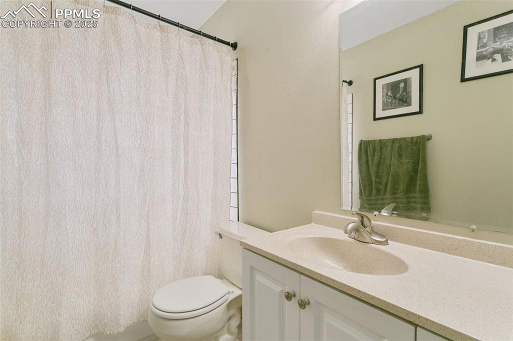 Image 20 of 26: Bathroom featuring vanity and curtained shower
