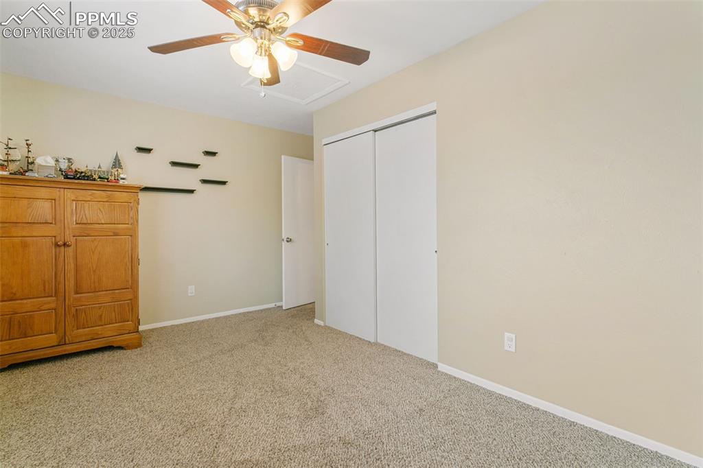 Image 21 of 26: Bedroom with carpet floors, a closet, and ceiling fan