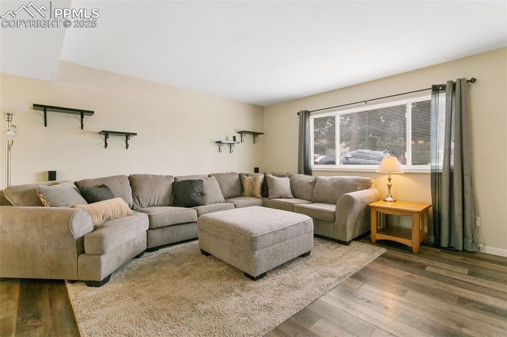 Image 5 of 26: Living room with wood finished floors