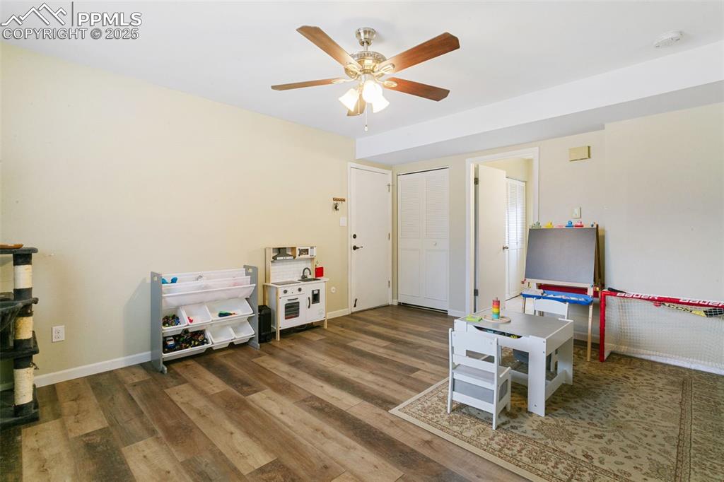 Image 6 of 26: Game room featuring wood finished floors and ceiling fan