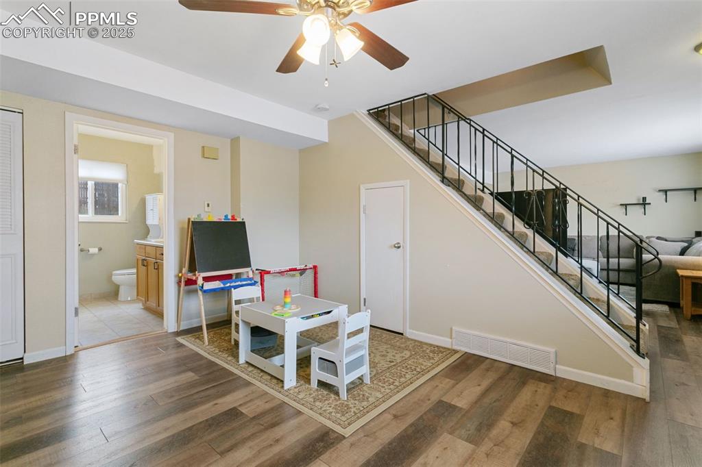 Image 9 of 26: Playroom featuring wood finished floors and a ceiling fan