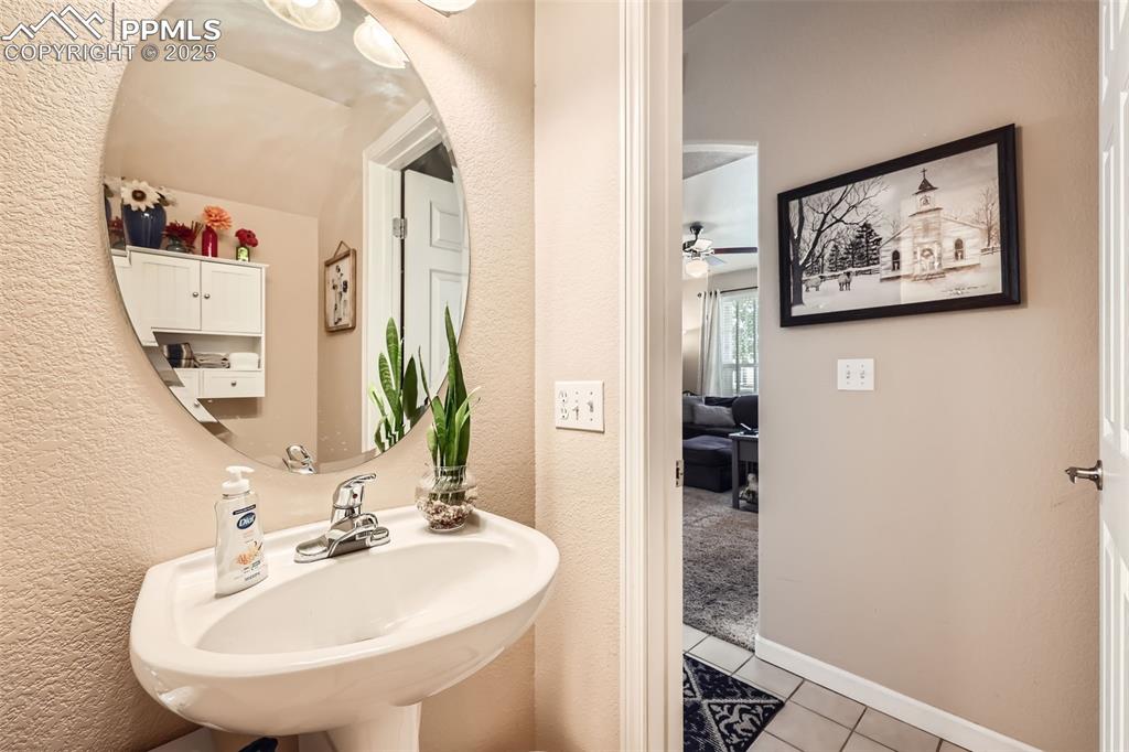 Image 12 of 26: Bathroom featuring tile patterned flooring and a textured wall