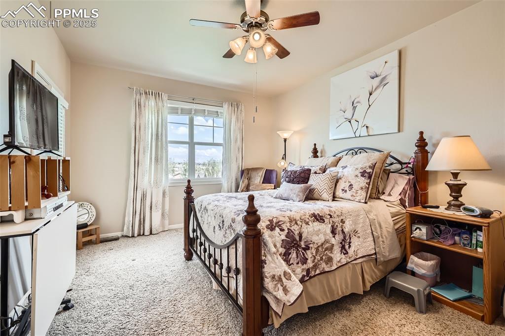 Image 13 of 26: Carpeted bedroom featuring baseboards and ceiling fan