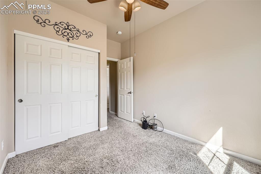 Image 18 of 26: Unfurnished bedroom with carpet floors, ceiling fan, and a closet