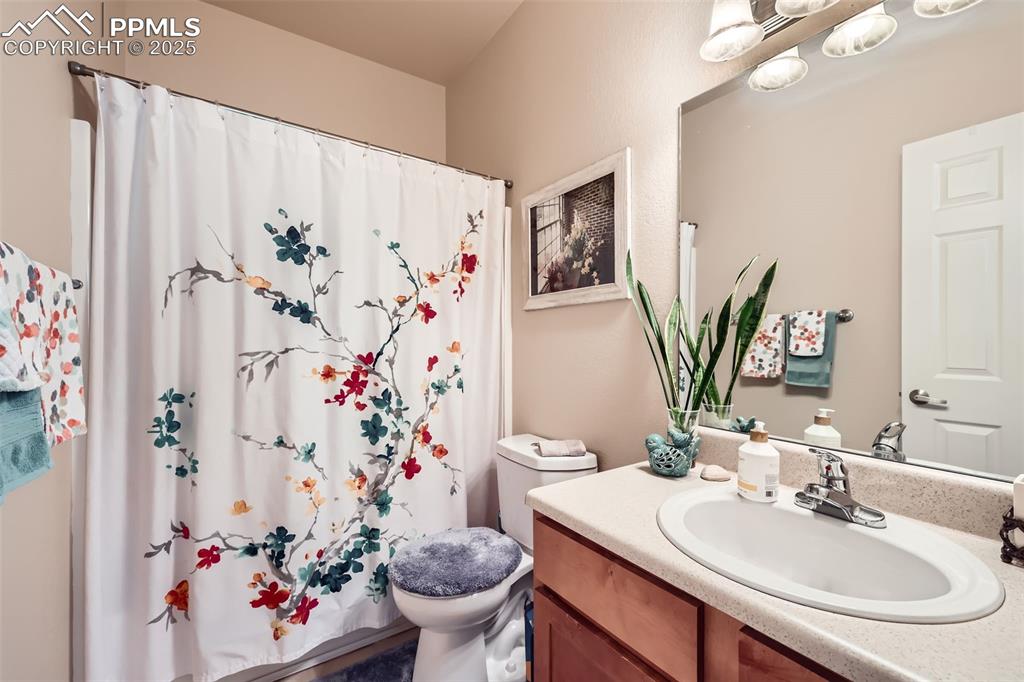 Image 20 of 26: Bathroom with vanity and a shower with curtain