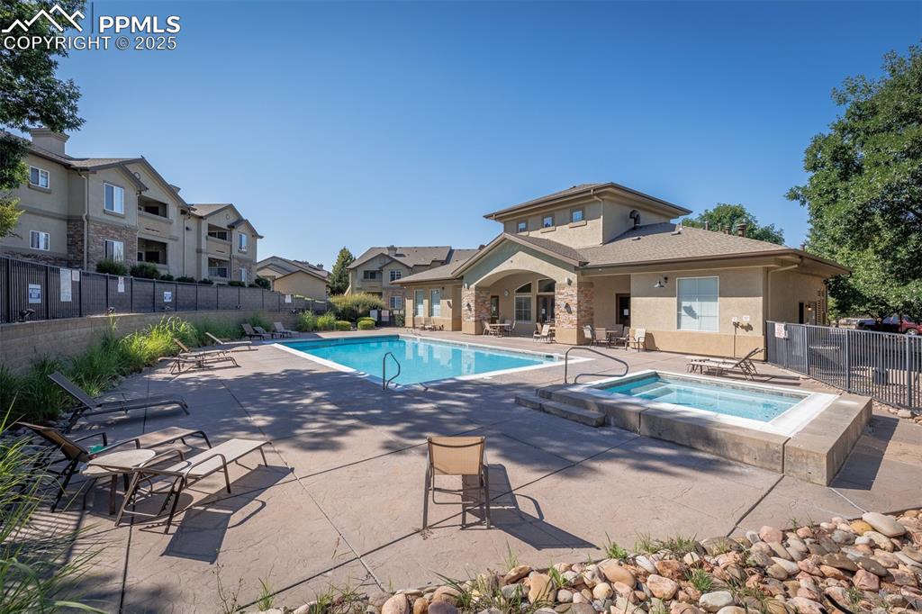Image 26 of 26: Community pool with a community hot tub, a patio, and a residential view
