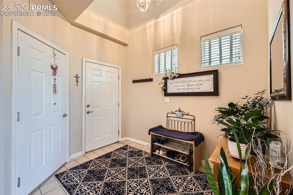 Image 7 of 26: Foyer with tile patterned floors and baseboards