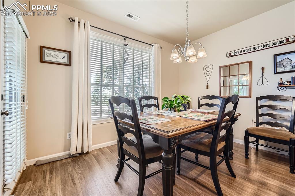 Image 8 of 26: Dining space featuring wood finished floors, plenty of natural light, and a