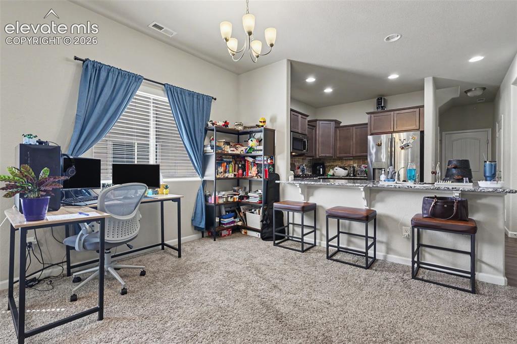 Image 8 of 26: Looking into the kitchen from the Dining Room area, you can see that the Ki