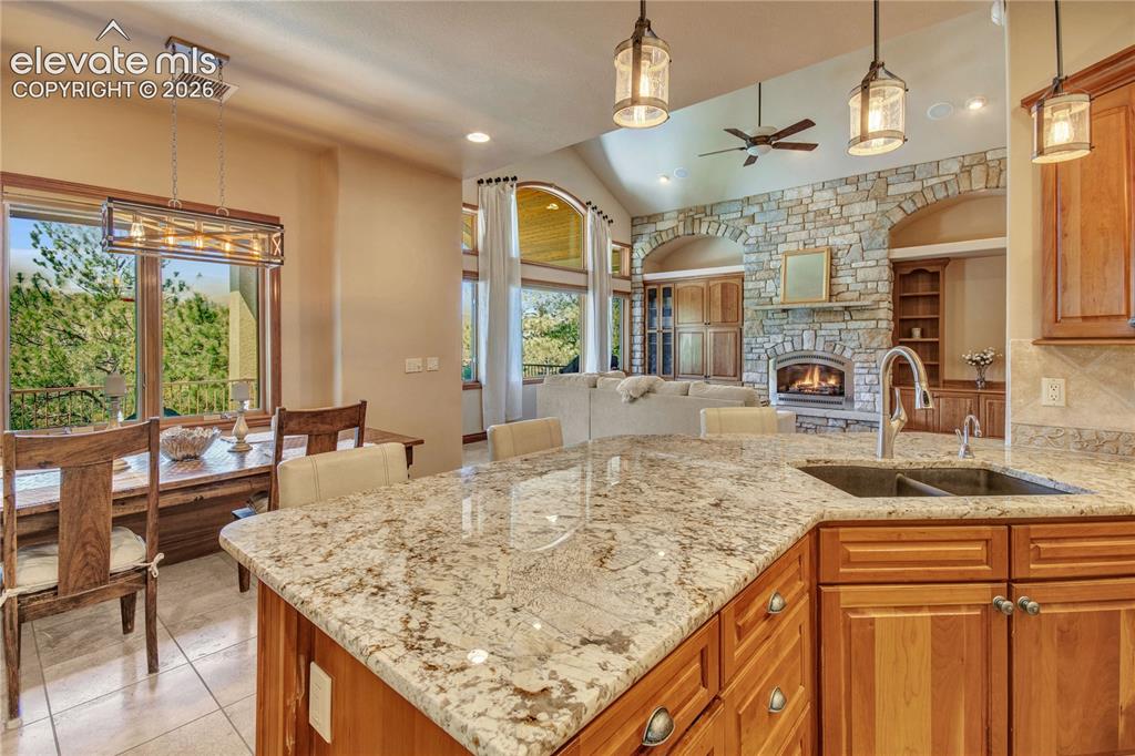 Image 22 of 50: Kitchen island featuring a granite countertop with an undermount double bas