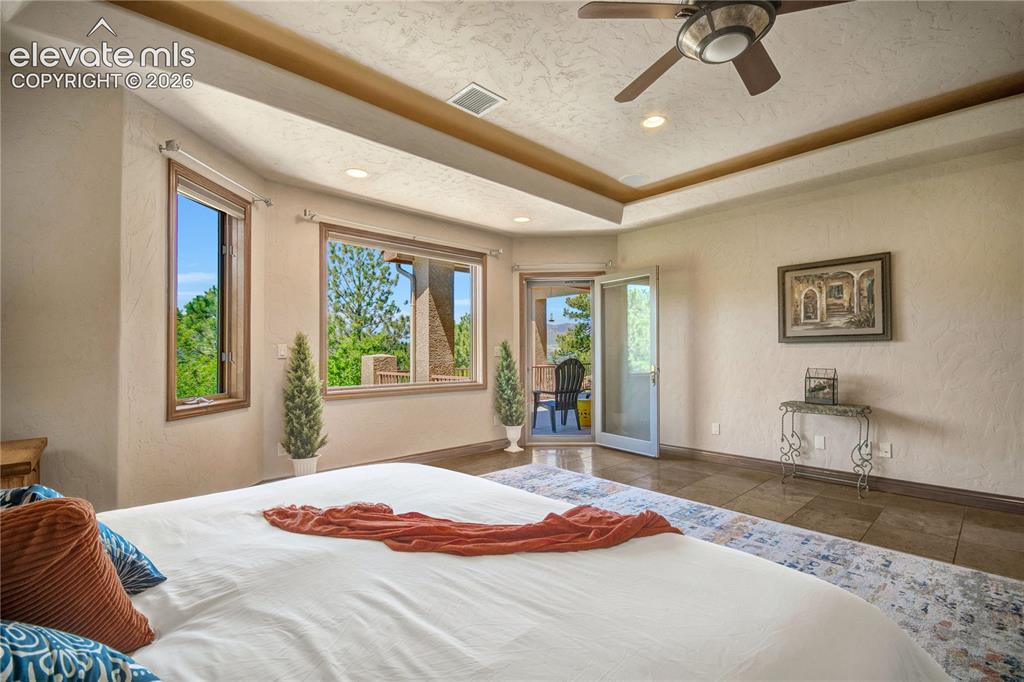 Image 25 of 50: Spacious room featuring multiple windows, a ceiling fan, recessed lighting,