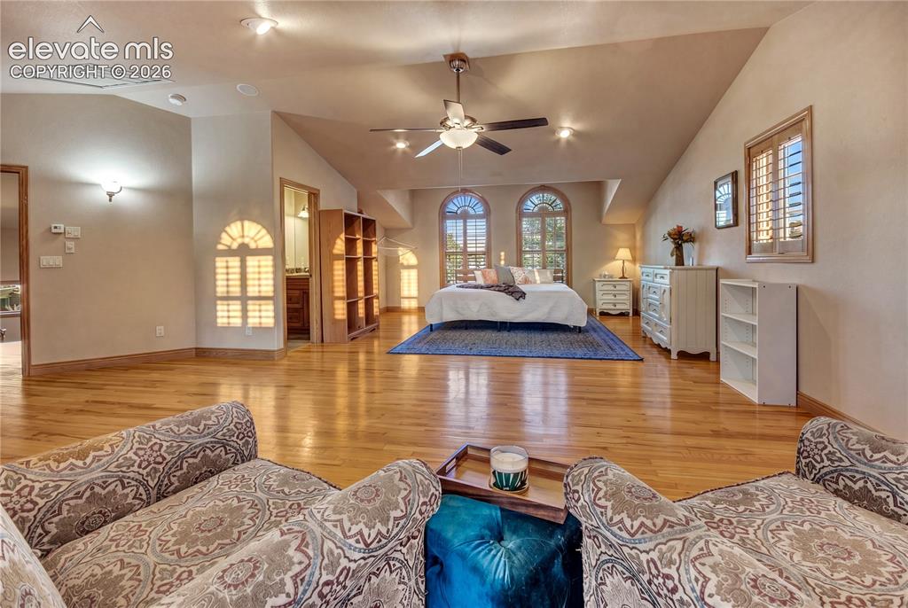 Image 32 of 50: Expansive room featuring light wood flooring and vaulted ceilings
