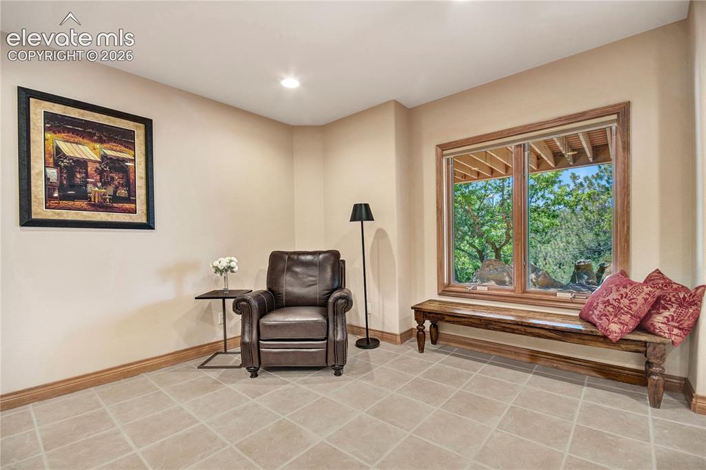 Image 36 of 49: Expansive window with wood trim, offering outdoor scenery