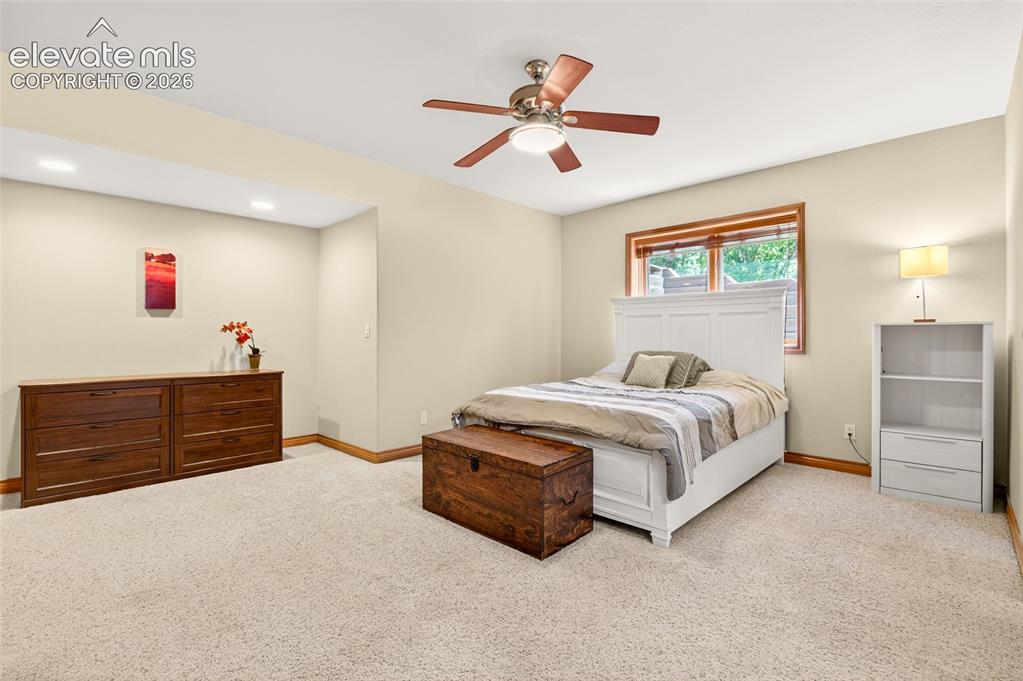Image 43 of 50: Spacious room featuring neutral wall tones, plush carpeting, wood-trim wind