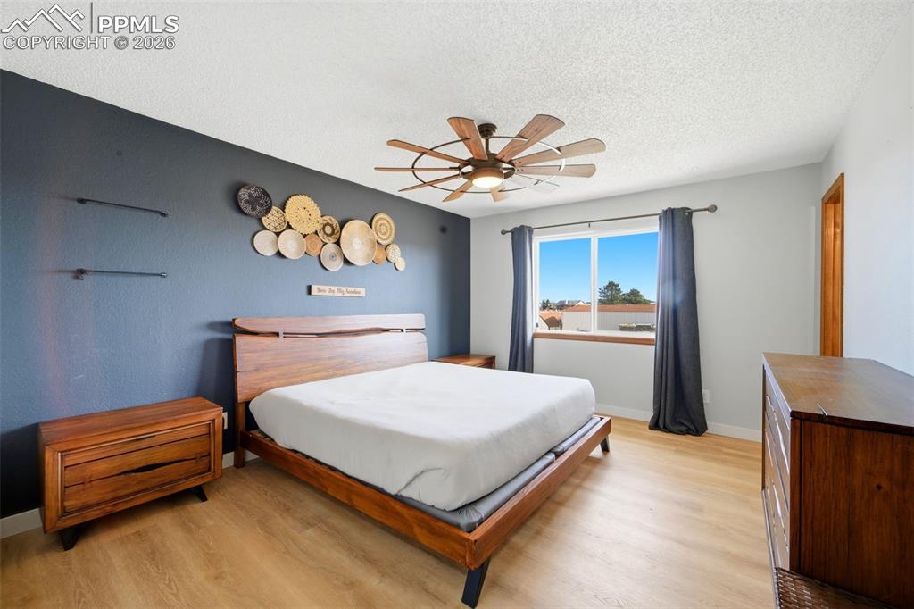 Image 16 of 37: Bedroom featuring light wood-style flooring, a textured ceiling, and a ceil