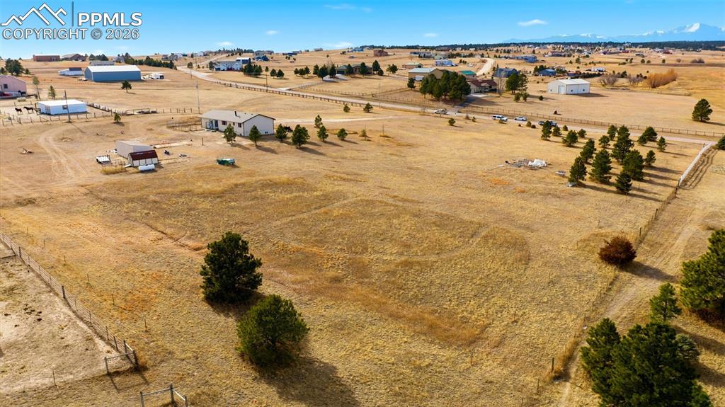 Image 33 of 37: Aerial view of sparsely populated area featuring a desert landscape
