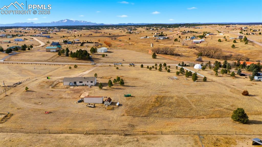 Image 34 of 37: Overview of rural landscape with a desert landscape and a mountain backdrop