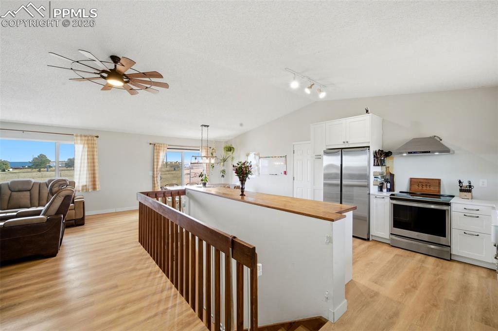Image 5 of 37: Kitchen featuring white cabinetry, appliances with stainless steel finishes