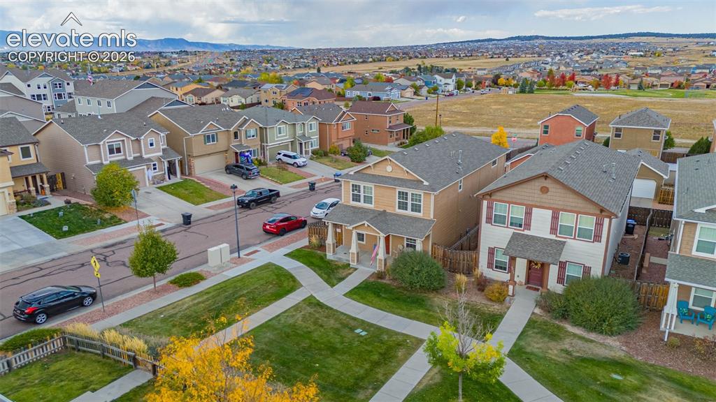 Image 23 of 30: Residential neighborhood featuring a curvilinear street layout and a centra