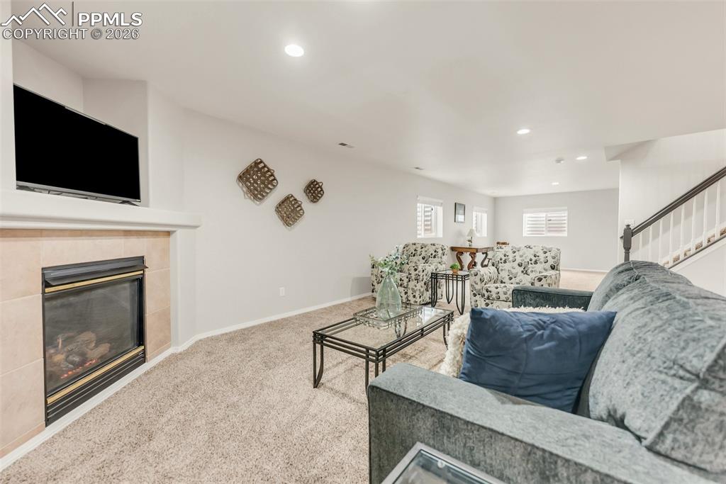 Image 28 of 43: Basement Family Room with second gas fireplace