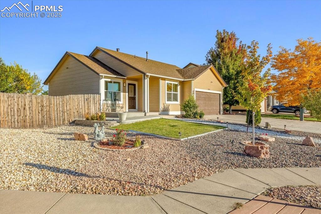 Caption: View of front of property featuring a porch, driveway, an attached garage, and a shingled roof