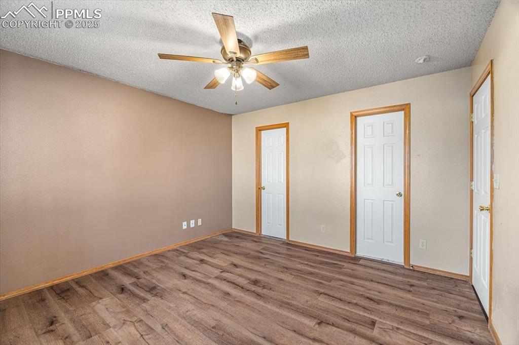 Image 11 of 27: Unfurnished bedroom featuring a textured ceiling, wood finished floors, and