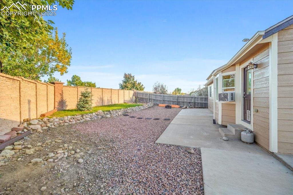 Image 20 of 27: View of fenced backyard