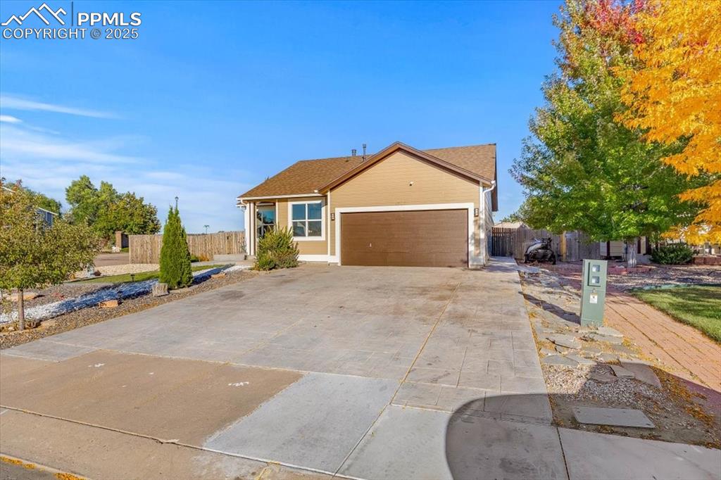 Image 21 of 27: Single story home featuring driveway and a garage