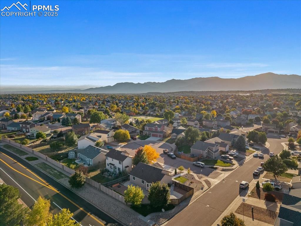 Image 25 of 27: Aerial perspective of suburban area featuring mountains