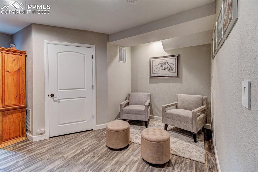 Image 16 of 32: Lower level rec room accesses the utility room with storage