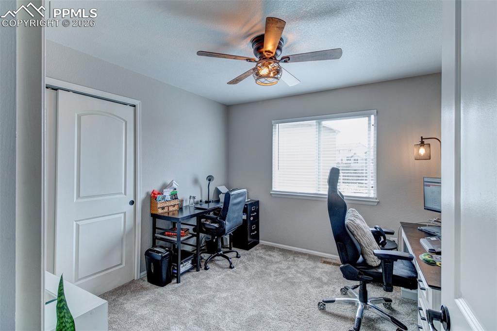 Image 25 of 32: Guest bedroom currently used as an office