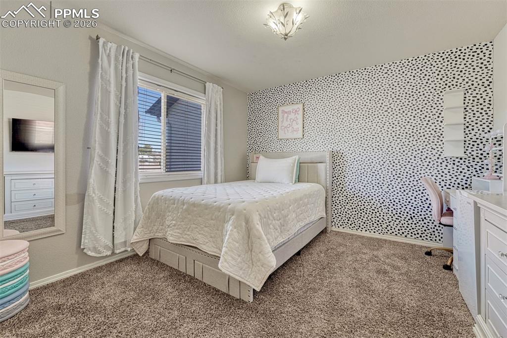 Image 17 of 42: Bedroom 2 on the main level with double closet and plush carpet