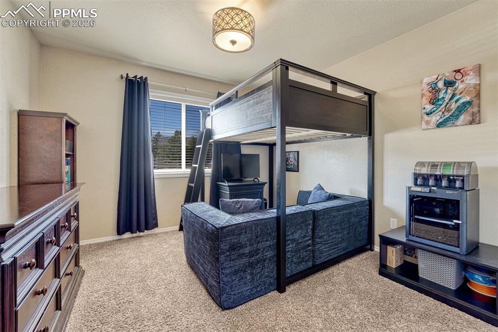 Image 19 of 42: Bedroom 3 on the main level with double closet and plush carpet
