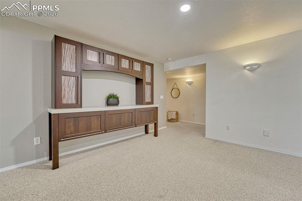 Image 24 of 42: Downstairs offers additional living or flex space and continues the home’s