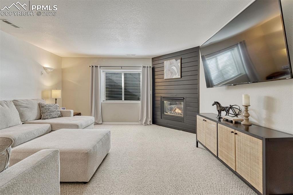 Image 25 of 42: The recreation room is ready for movie nights, game days, or cozy gathering