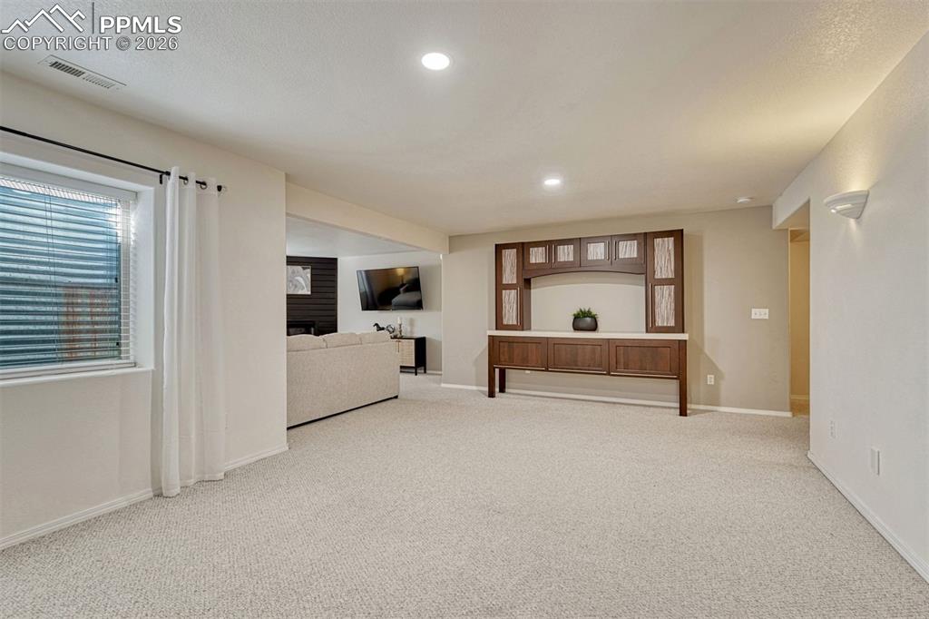 Image 27 of 42: The downstairs is especially versatile with multiple flex spaces. Imagine g