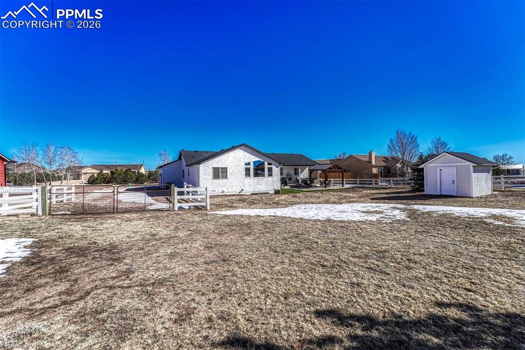 Image 38 of 42: RV or boat parking sits conveniently beside the home, eliminating storage f