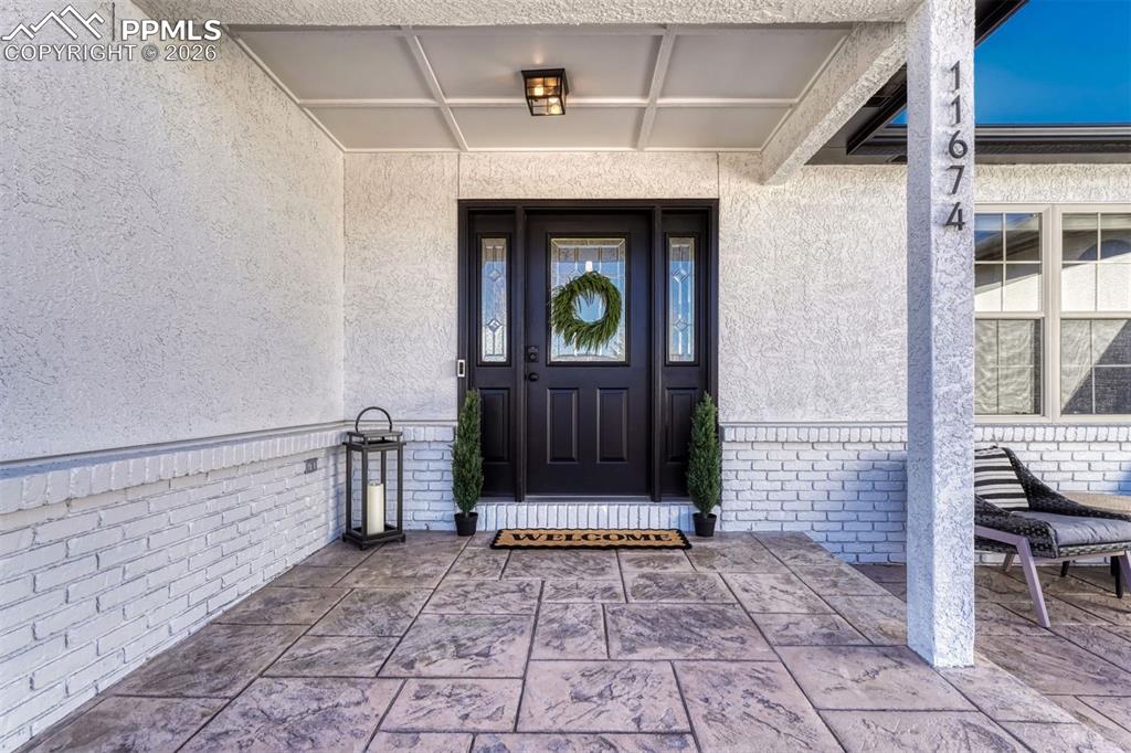 Image 7 of 42: The charming covered porch is ideal for Colorado’s ever-changing weather, o
