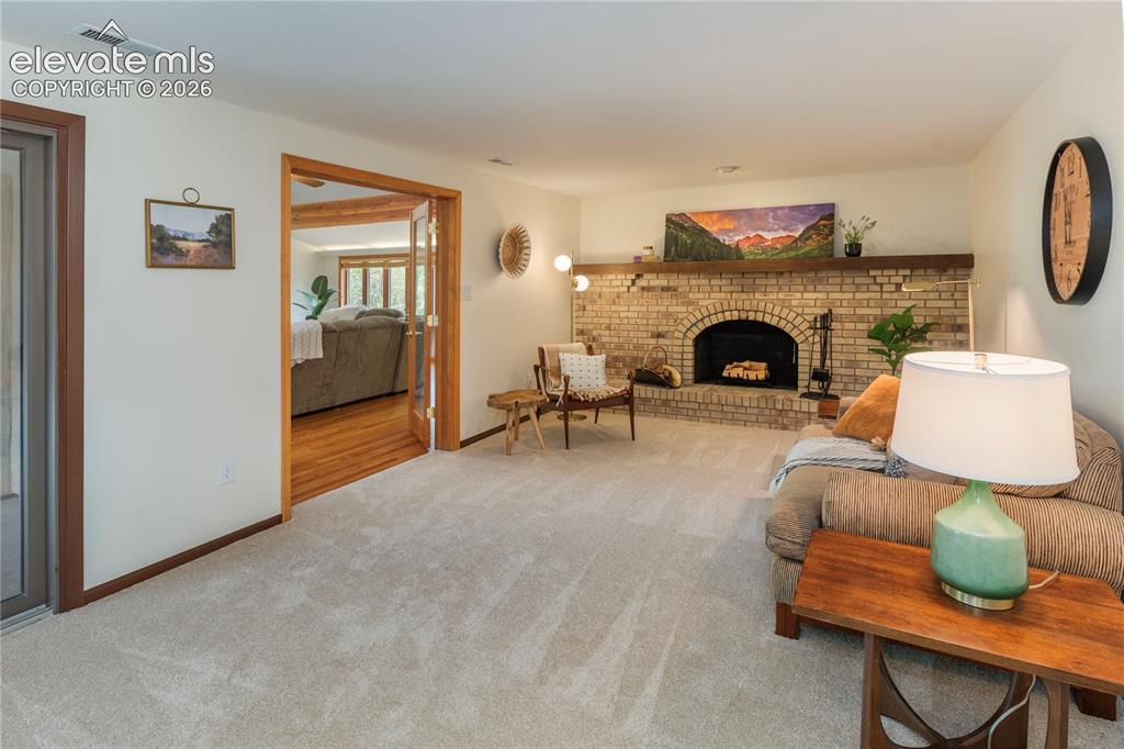 Image 13 of 50: The original family room offers a second fireplace with a recently cleaned 