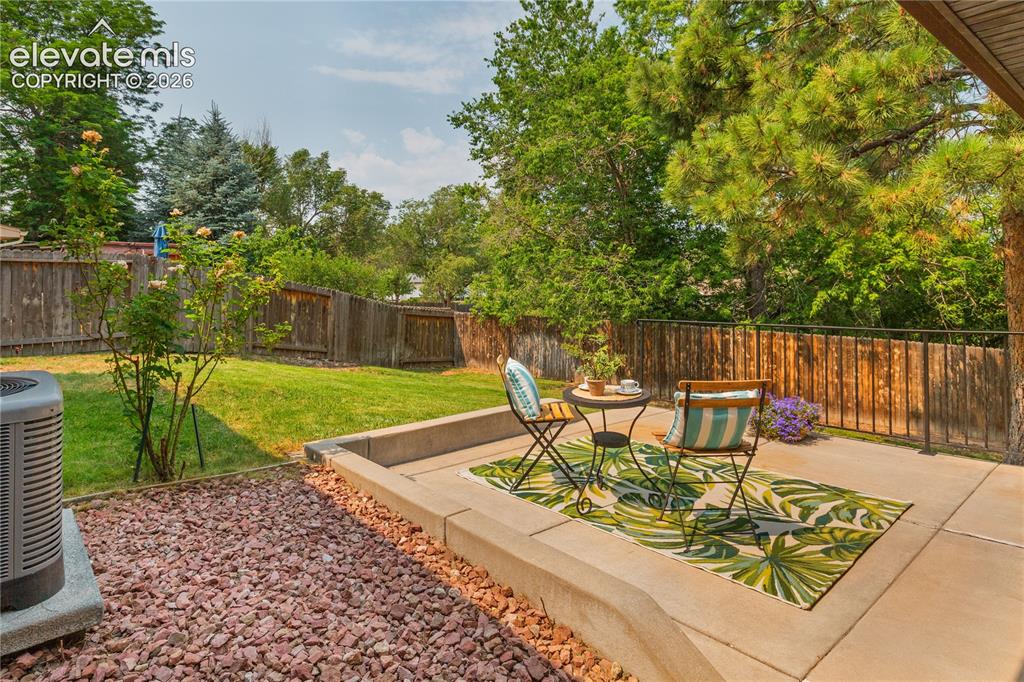 Image 16 of 50: Large lot with pine and deciduous trees plus a lovely rose bush off your pa