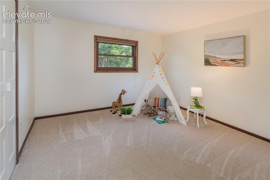 Image 35 of 50: Bedroom #2 with cedar-lined closet overlooks backyard and the mountains in