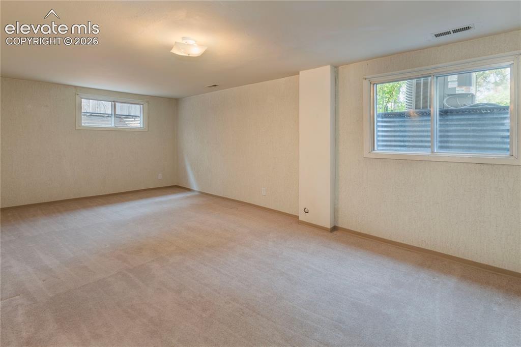 Image 38 of 50: Expansive basement rec room offers multiple options to suit your lifestyle.