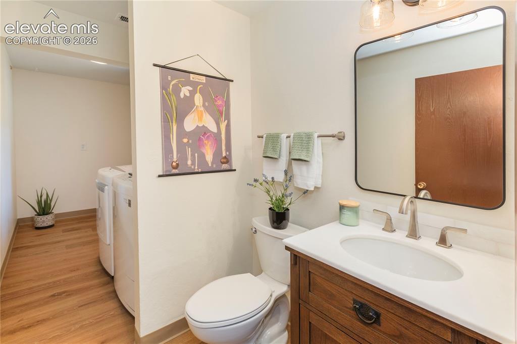 Image 40 of 50: Main-level bathroom features a new vanity, marble top and backsplash, brush
