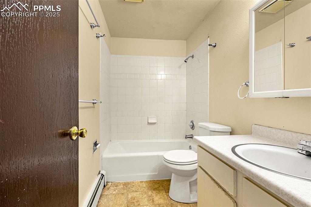Image 11 of 15: Full bathroom featuring baseboard heating, shower / washtub combination, va